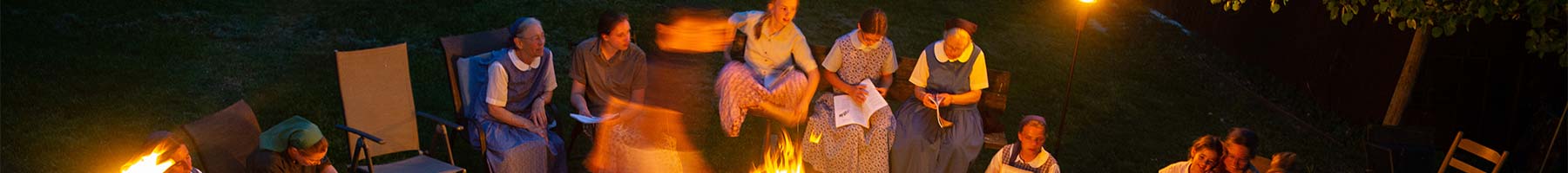 people singing around a campfire