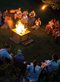 people singing around a campfire