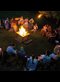 people singing around a campfire