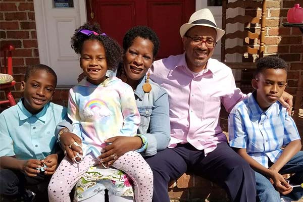 the author with her husband and children on their front steps