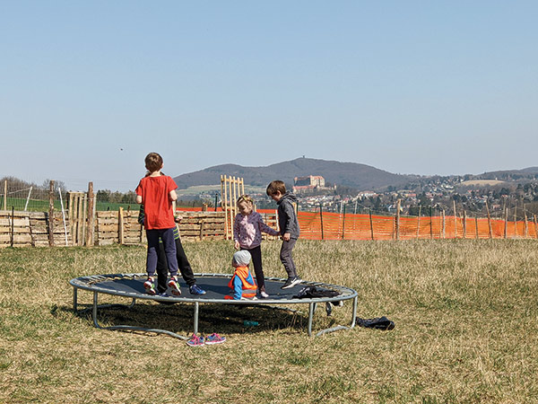 Ukrainian refugee children playing on a trampoline