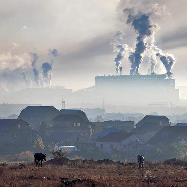 factory smokestacks with grey smog