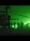 green tinged photograph taken through night vision goggles of US Marines boarding a helicopter