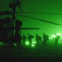 green tinged photograph taken through night vision goggles of US Marines boarding a helicopter