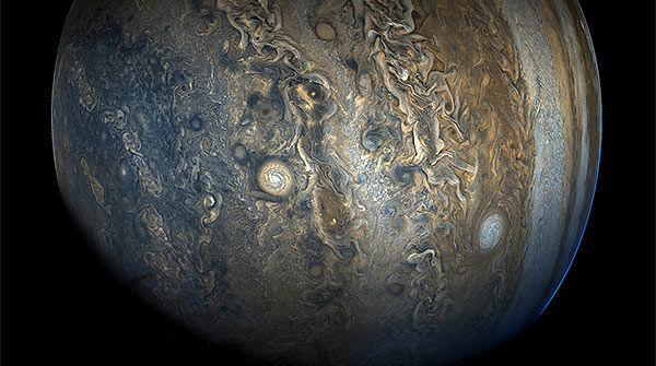 tan and blue swirls and patterns in the clouds of Jupiters atmosphere