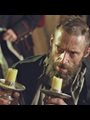 Hugh Jackman as Jean Valjean with two candlesticks