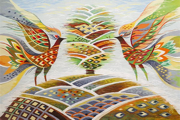 tapestry art of two birds in green, rust, brown, orange, and yellow