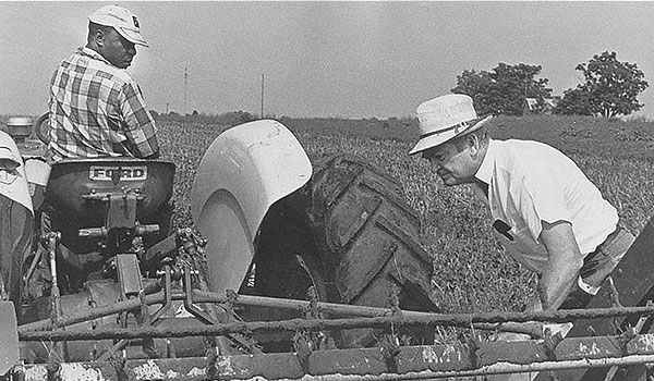 photo of Clarence Jordan working on a tractor