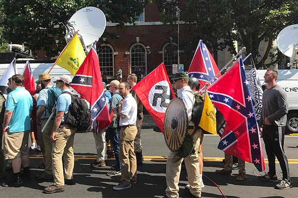 Alt-right members preparing to enter Emancipation Park holding Nazi, Confederate, and Gadsden "Don't Tread on Me" flags.