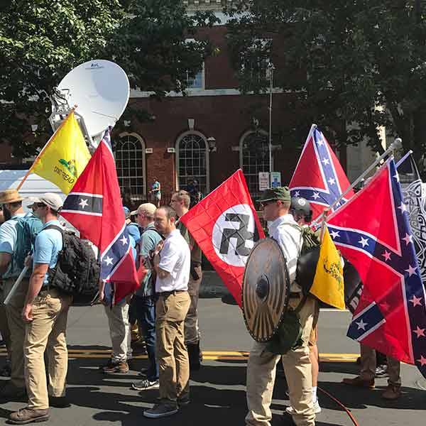 Alt-right members preparing to enter Emancipation Park holding Nazi, Confederate, and Gadsden Don't Tread on Me flags.