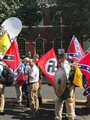 Alt-right members preparing to enter Emancipation Park holding Nazi, Confederate, and Gadsden Don't Tread on Me flags.