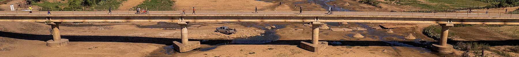 a bridge over the dried river bed of the Manambovo River