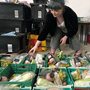 a woman sorting groceries into crates