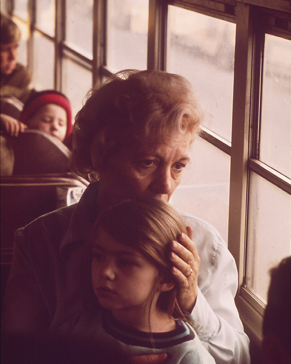 a worried mother and her child riding a bus