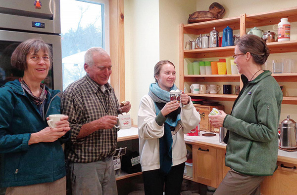 four people sharing coffee together