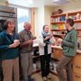 four people sharing coffee together