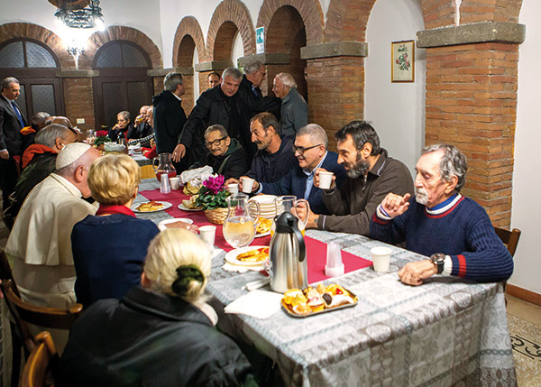 people enjoying a meal with Pope Francis
