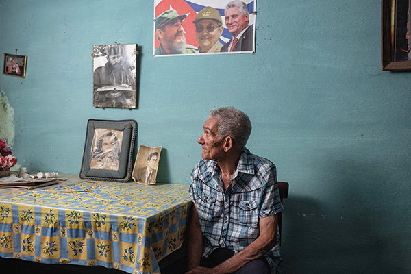 an old man sitting at a table