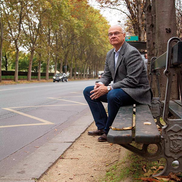 portrait of Tim Keller sitting on a bench