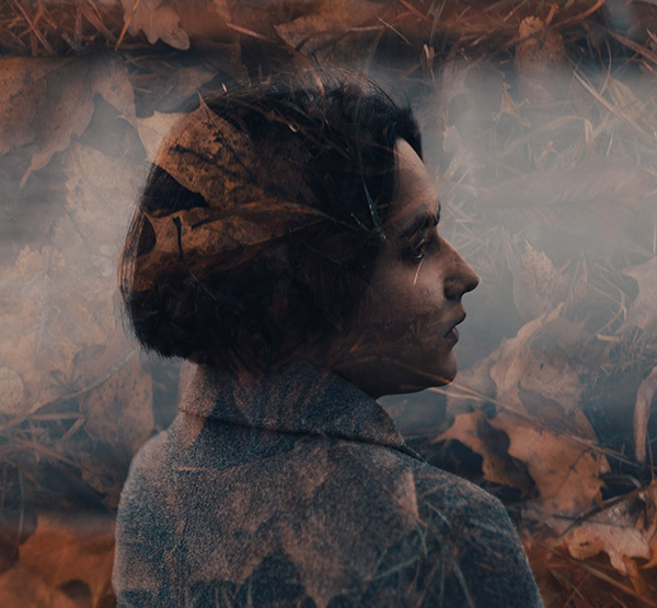 photo of a woman against a leafy background