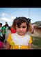 portrait of a refugee girl in a white and yellow dress