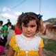 portrait of a refugee girl in a white and yellow dress