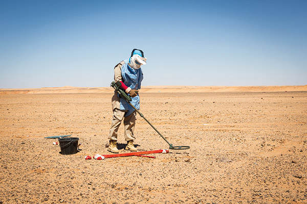 a woman looking for mines in the Sahara Desert