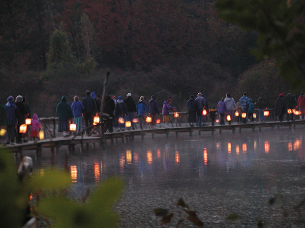 a community lantern walk near a lake