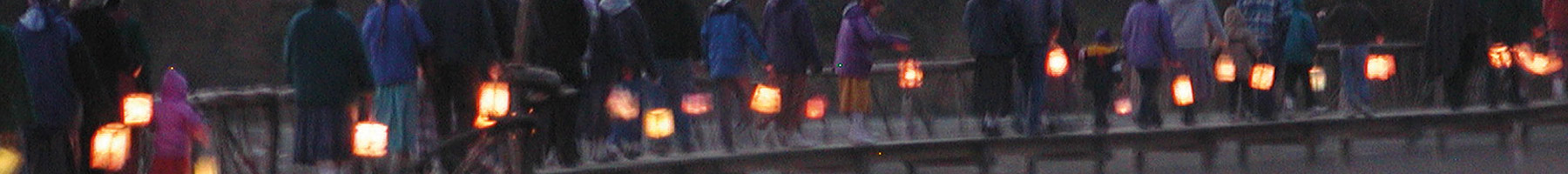 a community lantern walk near a lake