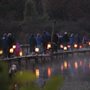 a community lantern walk near a lake