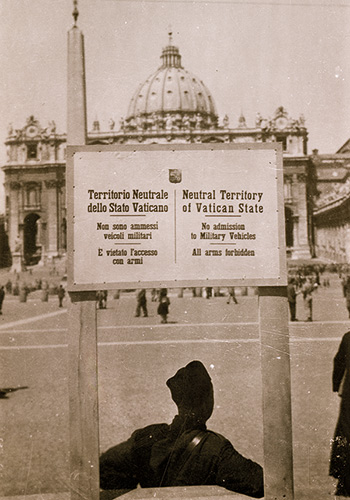 a soldier sitting in front of the Vatican