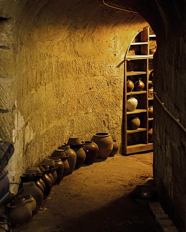 a dark hallway filled with ceramic pots