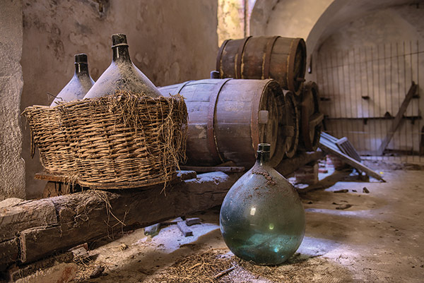 a cellar filled with barrels and flasks