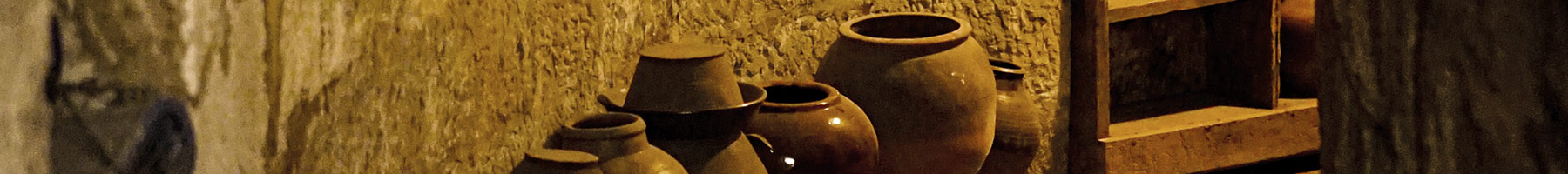 a dark hallway filled with ceramic pots