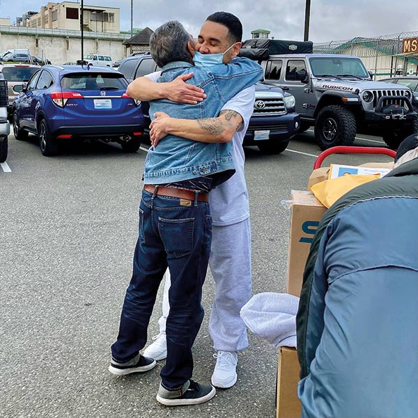a prisoner embracing his father minutes after his release
