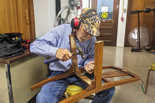 a man fixing a chair