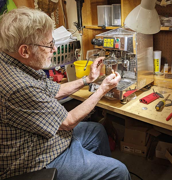 a man fixing a coffee maker