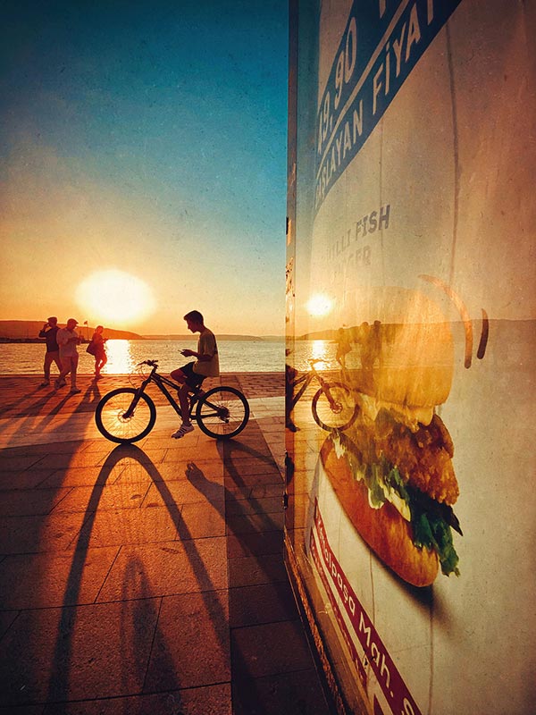 a man on a bike at sunset