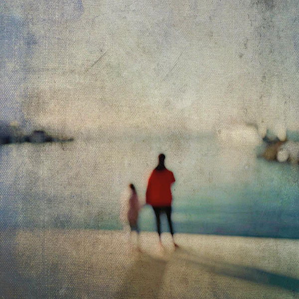 blurry image of a parent holding their childs hand