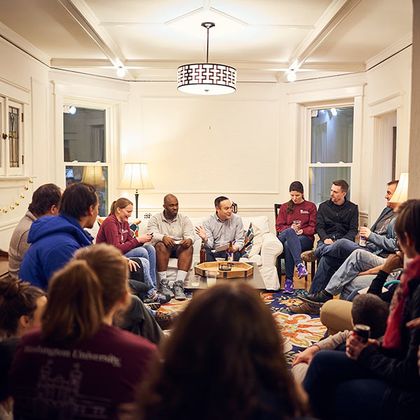 people sitting in a circle in a room