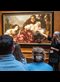 people looking at a painting