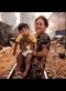 woman and child in poor neighborhood