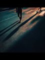 people's shadows on a road