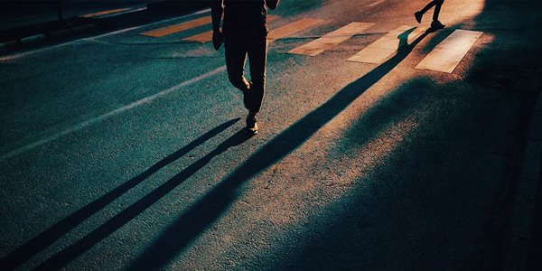 people's shadows on a road