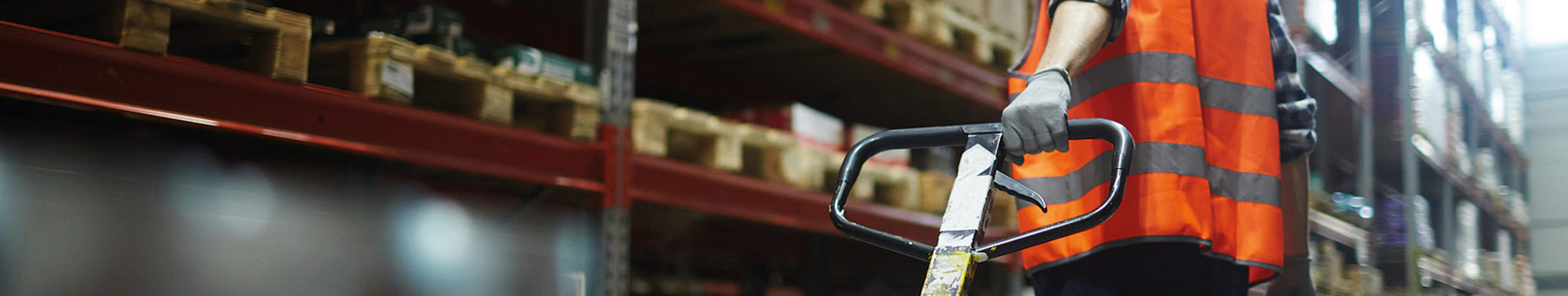a man pulling a pallet in a warehouse