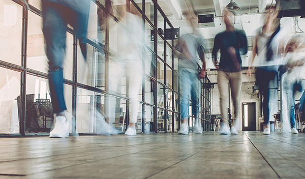 blurred people walking down a hall