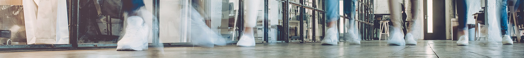 blurred people walking down a hall