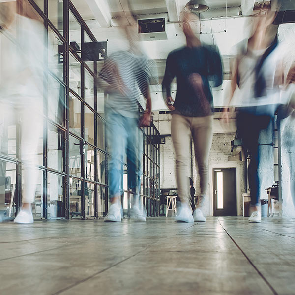 blurred people walking down a hall