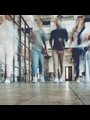 blurred people walking down a hall