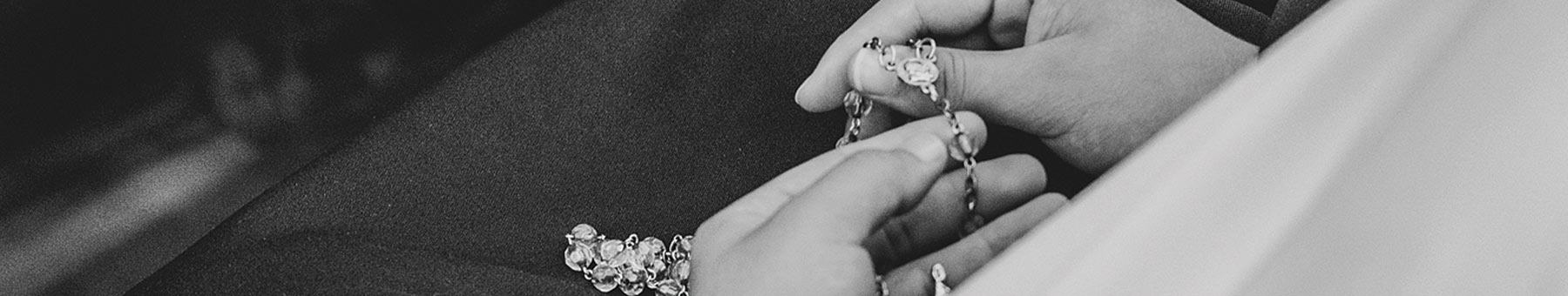 a woman holding rosary beads